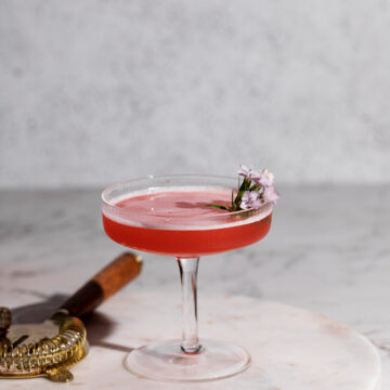 Pink cocktail in a coupe glass.